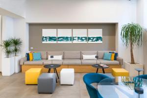 a living room with a couch and tables at Albatros Beach Hotel in Letojanni
