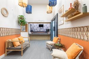 a living room with orange walls and chairs at Appart'City Classic Marseille Euromed in Marseille