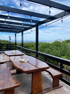 a group of wooden tables sitting on a balcony at Nautical @ Salt Shore Studios in Hermanus