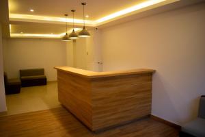 a lobby with a wooden counter in a room at The Grand ARK in Gangtok