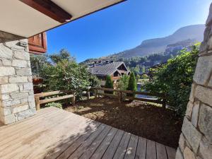 una terraza de madera con vistas a la montaña en Les Chalets d Or - B03 - Appt terrasse 4 pers, en Les Deux Alpes