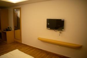 a room with a tv on the wall at The Grand ARK in Gangtok