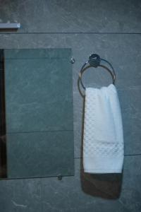 a white towel hanging on a towel rack in a bathroom at The Grand ARK in Gangtok