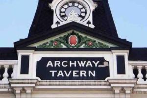 a clock tower with the words archway tavern on it at Studio 6- Archway Station in London