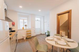 a kitchen with a table and chairs in a room at Best Houses 77 - Best Village I in Peniche