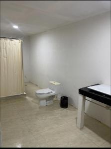 a bathroom with a toilet and a sink at Gorgona Beach House in Nueva Gorgona