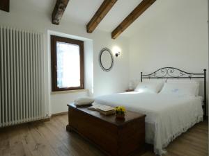 a bedroom with a bed and a table with a mirror at IL BORGHETTO in San Sisto