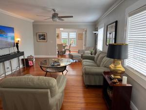 a living room with a couch and a table at Flamingo Park Bungalow! WALK TO DOWNTOWN WPB!! in West Palm Beach