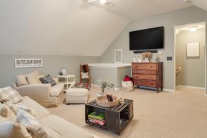 a living room with a couch and a tv at Spacious Lebanon Home with Pool 6 Mi to Downtown! in Lebanon