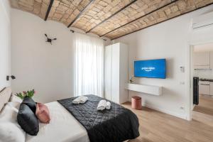 Schlafzimmer mit einem Bett und einem Flachbild-TV in der Unterkunft W STUDIO TERMINI in Rom