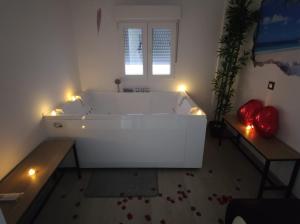 a white bath tub in a room with lights at apartamento con jacuzzi, El Rincón de Ayud in Calatayud