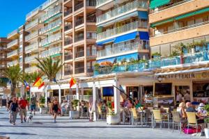 people walking on a street in front of a building at Hola Torrevieja in Torrevieja