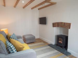 a living room with a couch and a fire place at Cilbronnau Lodge Cardigan in Llechryd