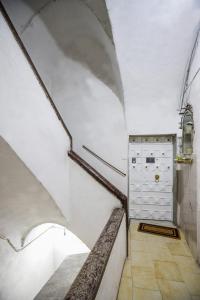 an attic hallway with a white ceiling and a cabinet at Napolidays Rua Catalana Apartment in Naples