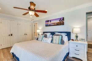 a bedroom with a bed with a ceiling fan at Bright Condo with Balcony, Steps to Oceanside Beach! in Oceanside