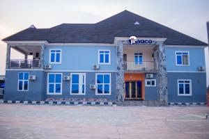 a blue building with a sign that reads virgo at Jimaco Hotels and Suites in Uyo