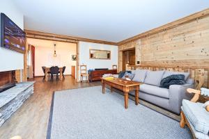 a living room with a couch and a table at Route de Tsarbouye 17, 4BR, Les Dauphinelles in Crans-Montana
