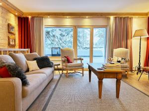 a living room with a couch and a table at Route de Tsarbouye 17, 4BR, Les Dauphinelles in Crans-Montana