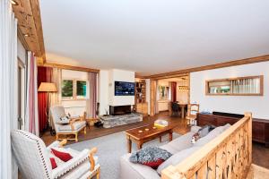 a living room with a couch and a table at Route de Tsarbouye 17, 4BR, Les Dauphinelles in Crans-Montana