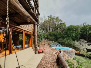 a house with a patio and a swimming pool at Cabana Alecrim in Bom Princípio