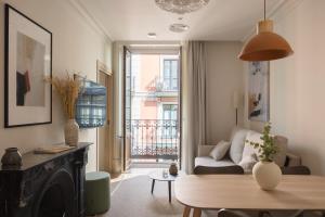 a living room with a couch and a table at Líbere Bilbao Ledesma in Bilbao