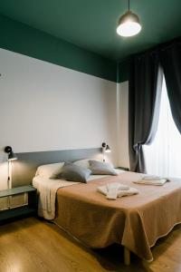 a bedroom with a large bed with a large window at Matlis in Alghero