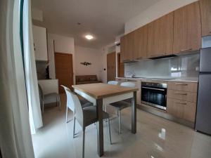 a kitchen with a wooden table and chairs in it at Residence Stella Marina in Cupra Marittima