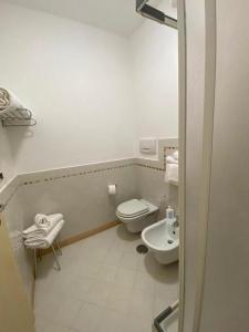 a small bathroom with a toilet and a sink at Appartamento 4 posti letto n 238 presso Residence Golf Hotel Punta Ala in Punta Ala +15 photos