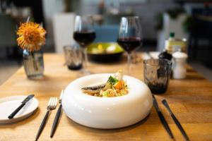 a plate of food on a table with wine glasses at voco Brussels City North by IHG in Vilvoorde