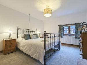 a bedroom with a large bed and a window at Strawberry Cottage Close RSPB and Wild Ken Hill - Crabpot Cottages Sheringham in Snettisham