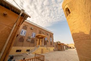 a building with a clock on the side of it at Arslan Boutique Hotel in Khiva