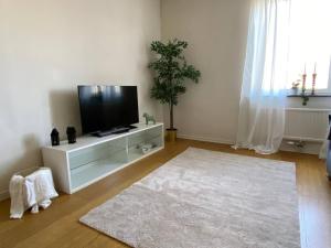 a living room with a flat screen tv on a cabinet at Spacious 1 bedroom flat, Lidingo in Kottla