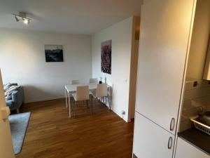 a dining room with a white table and chairs at Cozy 1 bedroom flat on Lindingo in Kottla +9 photos
