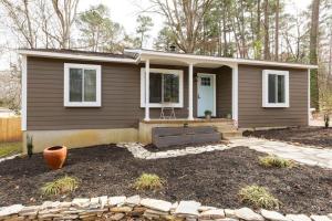 a small house with a front porch and a patio at Renovated Raleigh Bungalow in Raleigh