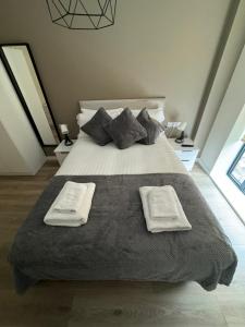 a bedroom with a large bed with two towels on it at L3 Apartments at Richmond Row in Liverpool