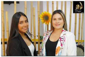two women standing next to each other with a sunflower at Hotel el Duque Internacional in Bogotá