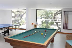 a pool table with two balls on top of it at Estelar Santamar Hotel & Centro De Convenciones in Santa Marta