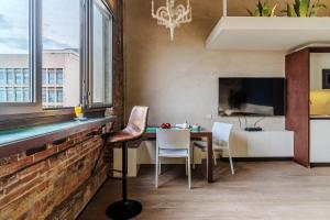 バルセロナにあるEnjoybcn Plaza Catalunya Apt.のテーブルと椅子とテレビのあるダイニングルーム