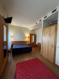 Postel nebo postele na pokoji v ubytování Hotel Ponte Molo