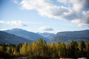 a view of a mountain range with trees and mountains at Domino Condo - Bunk Bed & Hot Tub in Revelstoke