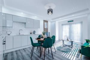 a kitchen and dining room with a table and chairs at Luxury Didsbury 2 Bed Apartment in Manchester