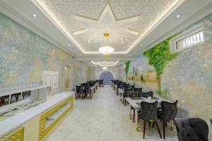 a restaurant with tables and chairs and a star on the ceiling at Arslan Boutique Hotel in Khiva