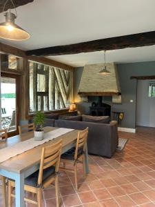 a living room with a table and a couch at Le Grand Chene in Moustier +17 photos