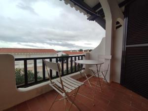 a balcony with a table and chairs and a view at Apartamento Menorca son parc in Son Parc