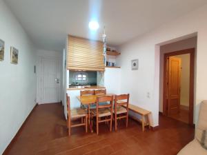 a kitchen and dining room with a table and chairs at Apartamento Menorca son parc in Son Parc +6 photos