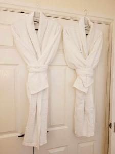 three white towels are hanging on a door at Apartment 2 in Darlington +52 photos