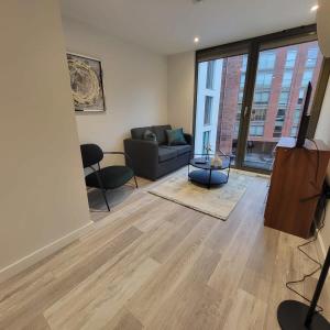 a living room with a couch and a table at Smart Central Birmingham 1 Bed Apartment in Birmingham