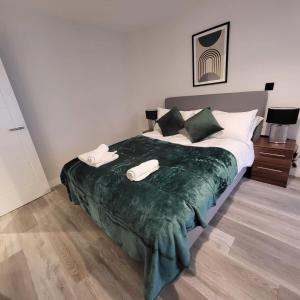 a bedroom with a large bed with two phones on it at Smart Central Birmingham 1 Bed Apartment in Birmingham