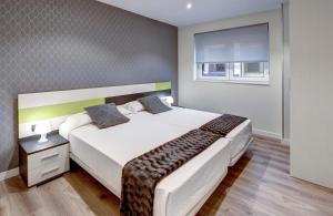 Postel nebo postele na pokoji v ubytování Apartamentos La Albarca