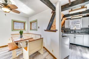 eine Küche mit weißen Schränken und einem Holztisch in der Unterkunft A-Frame Catskills Cabin with Scenic Views and Hot Tub! in Stamford